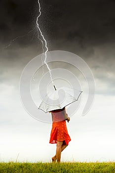 Girl with umbrella in storm