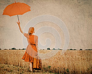 Girl with umbrella and suitcase at outdoor
