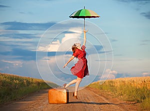 Girl with umbrella and suitcase