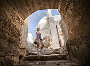 Girl under a arc in an old village