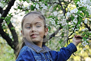 Girl under blooming spring tree