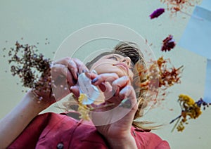 Girl from under glass table while she prepares leaves before brew a tea
