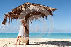 Girl under palm umbrella