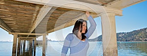 Girl under a pier at vacation resort