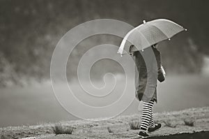 Girl under rain with umbrella