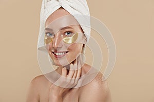 Girl with undereye patches and towel on head photo