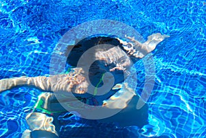 Girl underwater in a pool