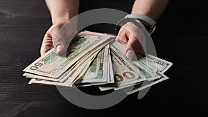 Girl Unfolding Bundle Of Usa Dollars In Hands