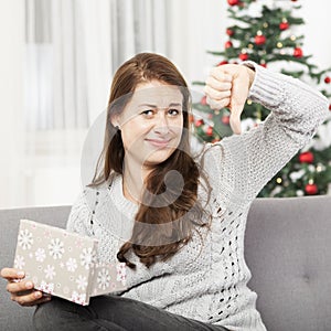 Girl is unhappy about christmas gift and thumb down