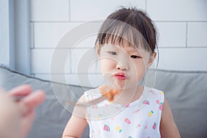 Girl with unhappy face between lunch