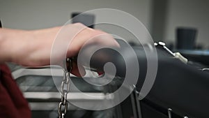 girl unlocking a supermarket cart with the coin