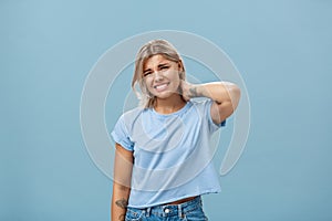 Girl unwilling to go with friend feeling awkward and unsure how say no frowning and clenching teeth making apologizing