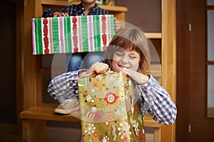 Girl unwrapping a Christmas present