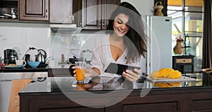 Girl Use Tablet Computer Drink Juice Laughing, Young Woman In Kitchen Studio Modern House Interior