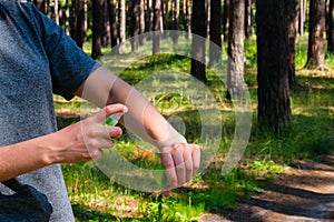 Girl uses the spray against mosquitoes photo