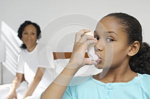 Girl Using Asthma Inhaler photo