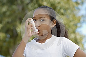 Girl Using Asthma Inhaler photo