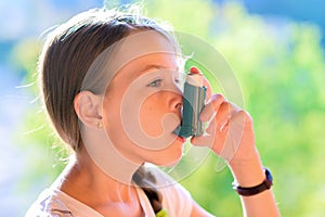 Girl using asthma inhaler