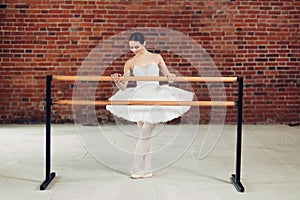 Girl using the barre to support her during exercises