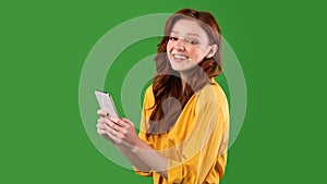 Girl Using Cellphone Texting In Social Media Standing, Studio Shot