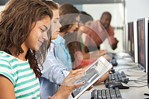 Girl Using Digital Tablet In Computer Class