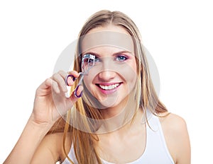 Girl using an eyelash curler photo