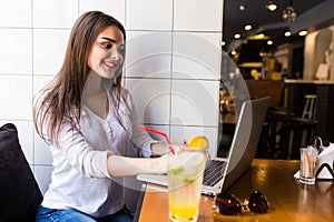 Girl using laptop and drink fresh at cafe