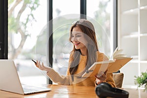 girl using laptop at home looking at screen typing chatting reading writing email. Young woman having virtual meeting