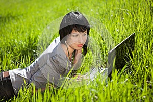 Girl using laptop outdoors