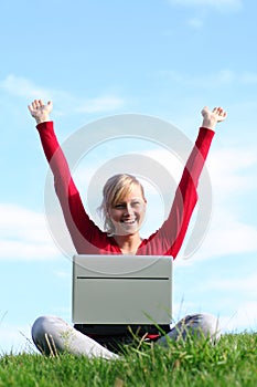 Girl using laptop outdoors
