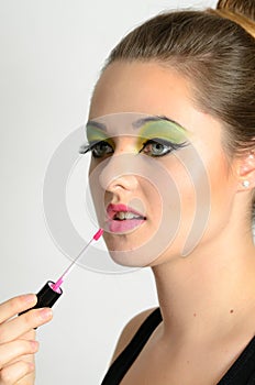 Girl using lip gloss