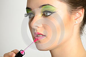 Girl using lip gloss
