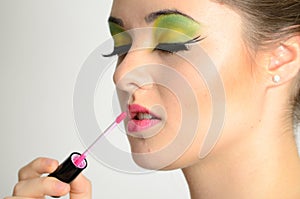 Girl using lip gloss