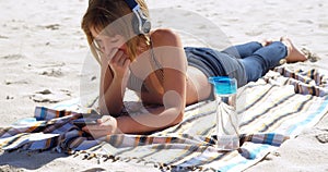 Girl using mobile phone in the beach 4k