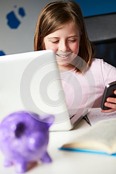 Girl Using Mobile Phone Instead Of Studying In Bedroom