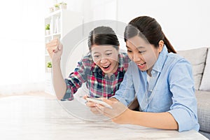 Girl using mobile smartphone playing game