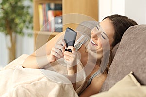 Girl using a phone comfortably at home