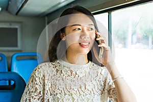 Girl using phone on public bus