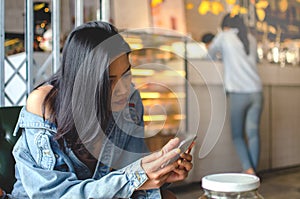 Girl using smart phone in cafe