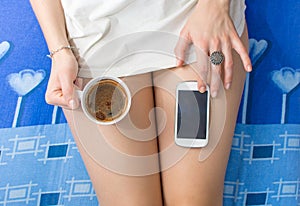 Girl using smart phone and havin coffee