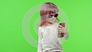 Girl using smartphone. Child emotionally talking on mobile phone, take selfie