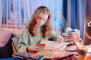 Girl Using Smartphone While Doing Homework
