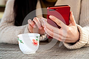 Girl using smartphone in indoors workplace at home