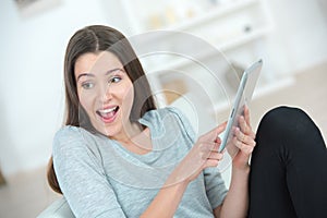 Girl using tablet delighted expression