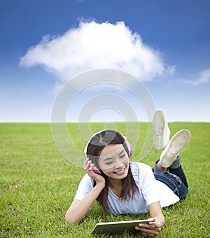 girl using touch pad computer with headphone