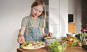 Girl with vegetables at kitchen