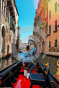 Girl in Venice on Gondola ride romance in boat happy on travel vacation holidays
