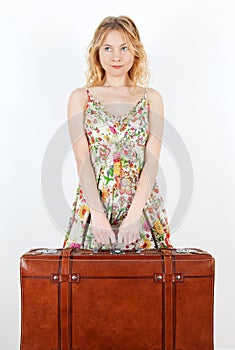 Girl with vintage suitcase anticipating travel