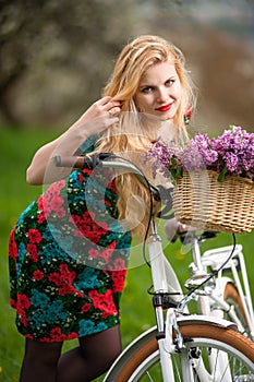 Girl with vintage white bicycle with flowers basket
