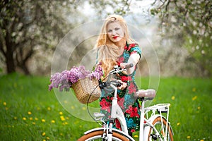 Girl with vintage white bicycle with flowers basket